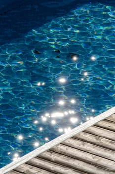 Stars on the blue water of a swimming pool