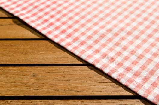 Red and white checkered tablecloth on a wooden table