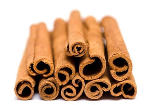 Extreme close-up of cinnamon rods on white background