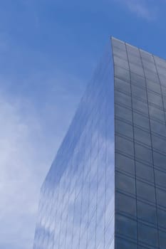Skyscraper with clouds reflection. Vertically.