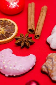 Star anise and gingerbread on red background