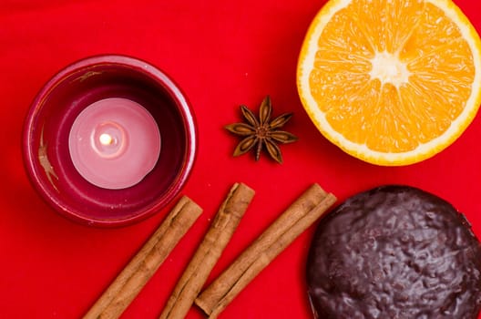 Orange,star anise,cinnamon sticks and a gingerbread with chocolate