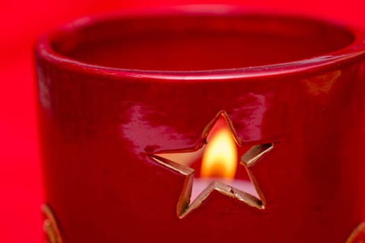 Star in a candlestick with a fuzzy flame of a candle