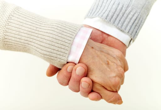 Seniors holding hands indicating their commitment to each other