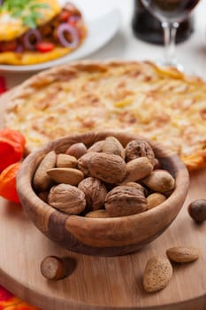 Nuts in the bowl with apple pie