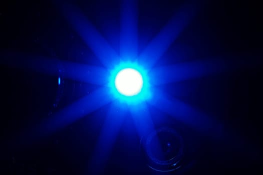 Lamp radiating blue light at dark surgery room