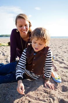 Mother and son relaxing and spending time together at the beach.