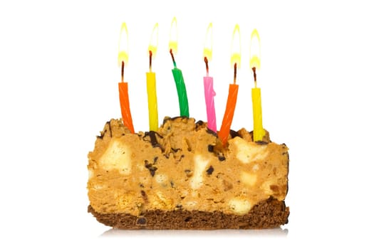 Piece of cake with burning candles on a white background