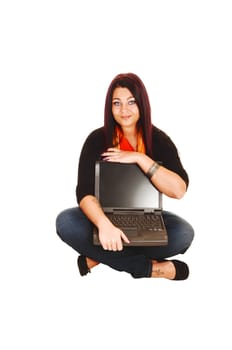 A young pretty woman sitting on the floor with a laptop on her lap and showing her computer to the people, for white background.