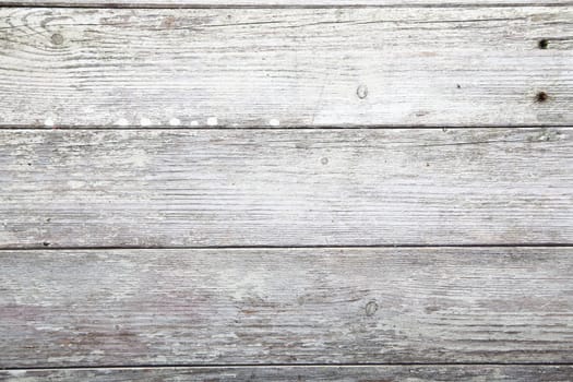 Abstract background of weathered wooden plank texture with remnants of old paint, crackes and wood grain