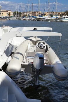 Dinghy with outboard engine on a catamaran sailing yacht in the port of Gruissan in the south of France