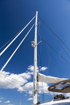 Close-up of a modern catamaran sailing yacht in front of blue sky