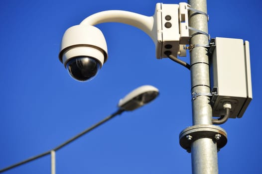Hi-tech dome type camera over a blue sky