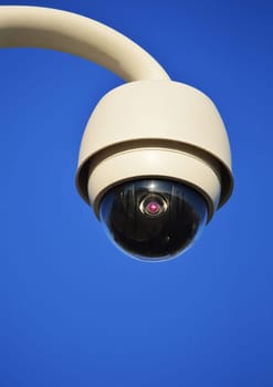 Hi-tech dome type camera over a blue sky