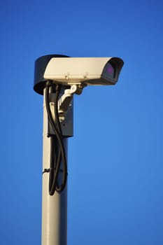 Security camera over a blue sky