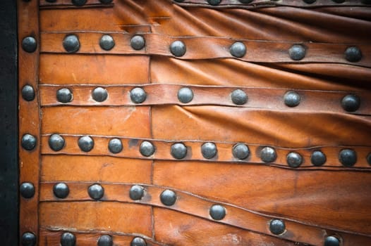 background from the skin with a wrought-iron rivets