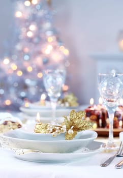 Place setting with Christmas tree in background