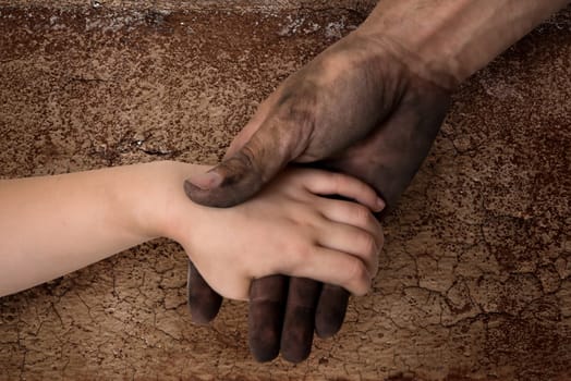black dirty man hands holding kid clean hand concept