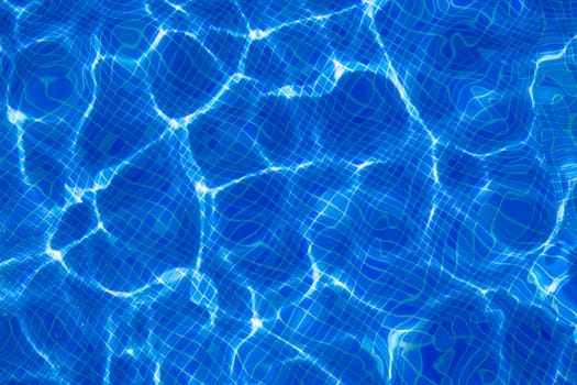Blue tiles pool with ripple water reflection as a summer background