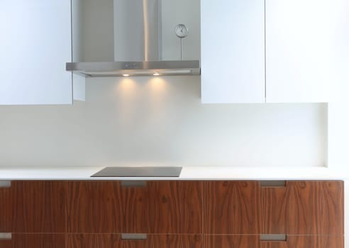 Actual modern kitchen in white and walnut wood interior house