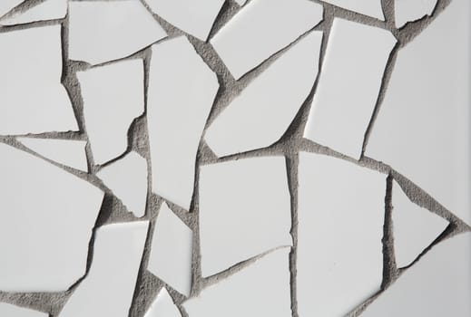 trencadis mosaic of white broken tiles in Mediterranean with cement gray joints
