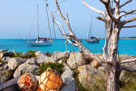Aqua mediterranean in formentera with fishing buoys and sailboats