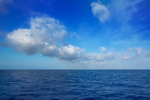 cumulus clouds in blue sky over ocean water horizon