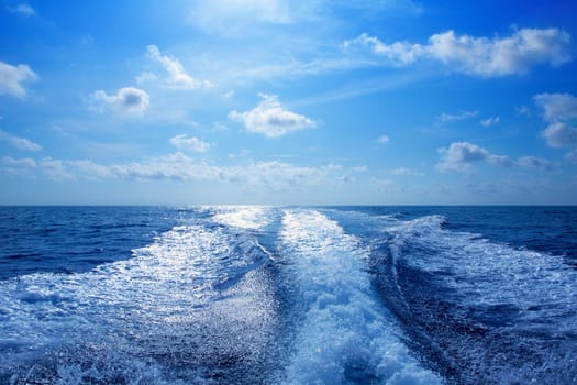 Boat wake speedy prop wash foam in blue sky at Mediterranean