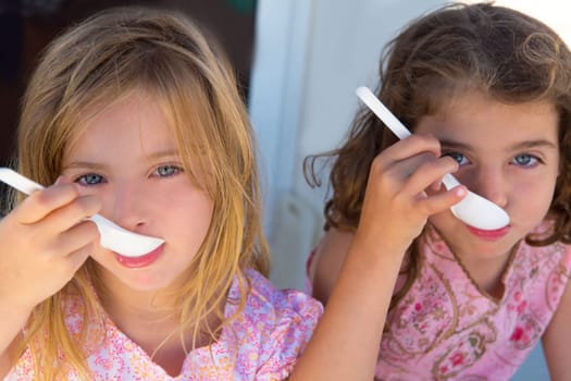 Blue eyes kids sister girl eating breakfast with spoon