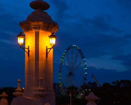 City of valencia night bridge Puente del Mar streetlights and ferry wheel