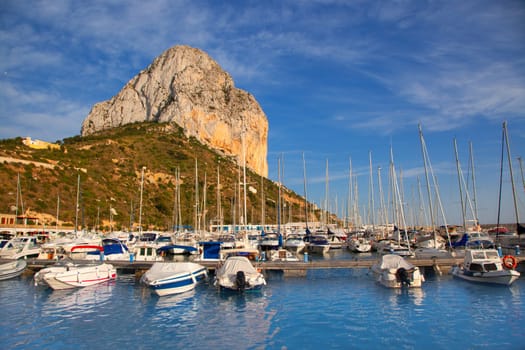 Calpe in alicante with Penon Ifach mountain and marina boats