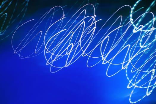 Abstract motion blurred lights on blue background