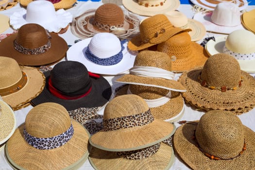 Hats display on a street market outdoor under sunny summer light