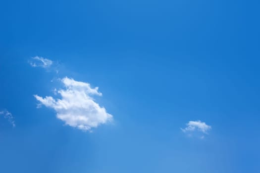 Blue sky with one cumulus and sunlight