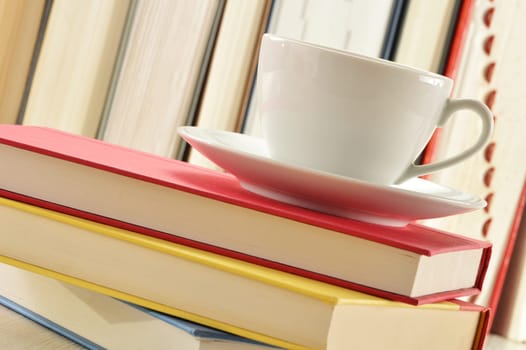 Composition with stack of books and cup of coffee