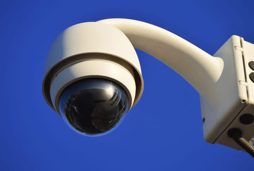Hi-tech dome type camera over a blue sky