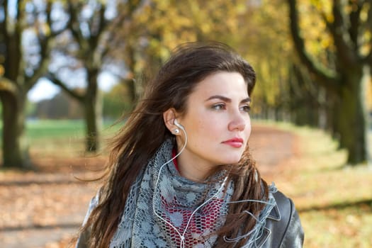 woman walking in park listening music