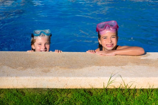 Blue eyes children girls on on blue pool poolside smiling with snorkel glasses
