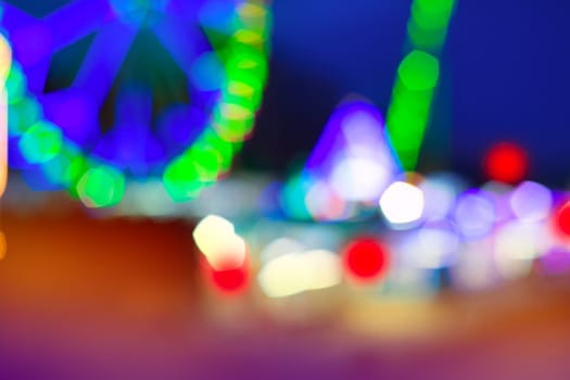 colorful ferrys wheel fairground night lights over blue sky
