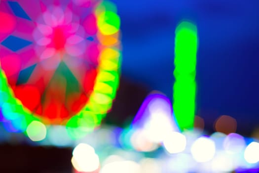 colorful ferrys wheel fairground night lights over blue sky