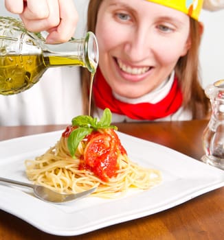 smiling chef garnish an Italian pasta dish