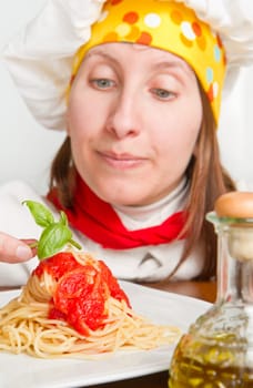 smiling chef garnish an Italian pasta dish
