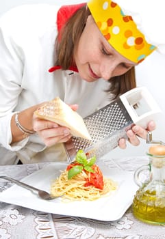 smiling chef garnish an Italian pasta dish