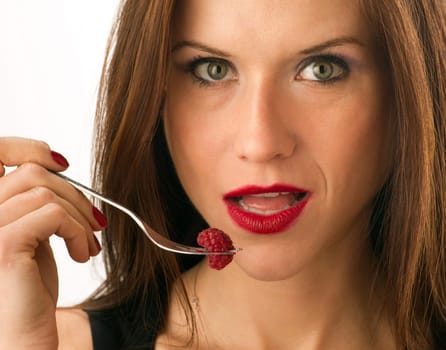 Woman eats Raspberry on a Fork