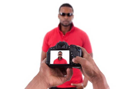 African american photographer taking studio pictures of a young black man