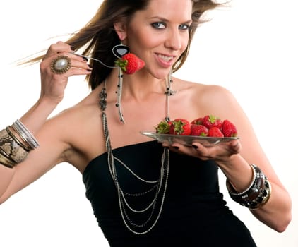 Woman eats Strawberry with a fork