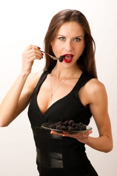 Woman eats Blackberries on a Fork