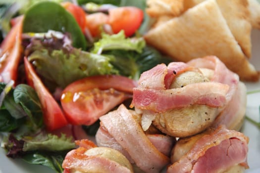 Delicious whole mushrooms wrapped in bacon strips ready to serve.