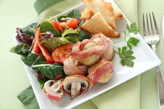 Delicious whole mushrooms wrapped in bacon strips ready to serve.