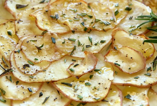 Delicious crispy baked potato chips with rosemary ready to serve.